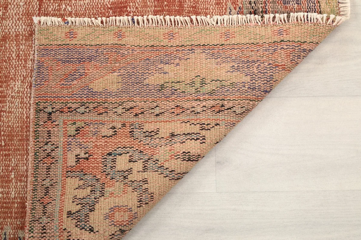 Detailed view of the rug's reverse side, illustrating the hand-knotted construction and fringe