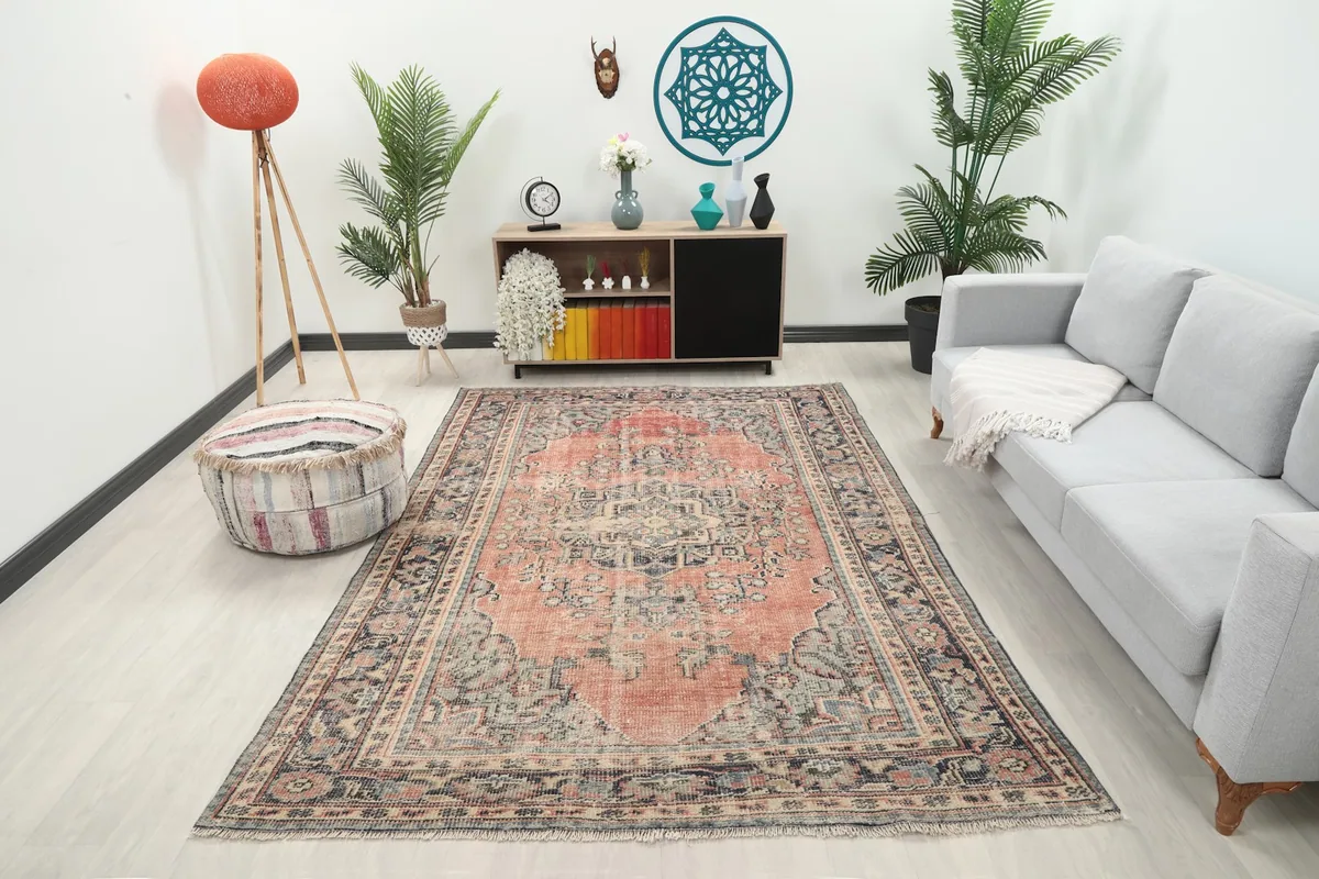 Vintage Anatolian rug displayed in a modern living room setting with a gray sofa
