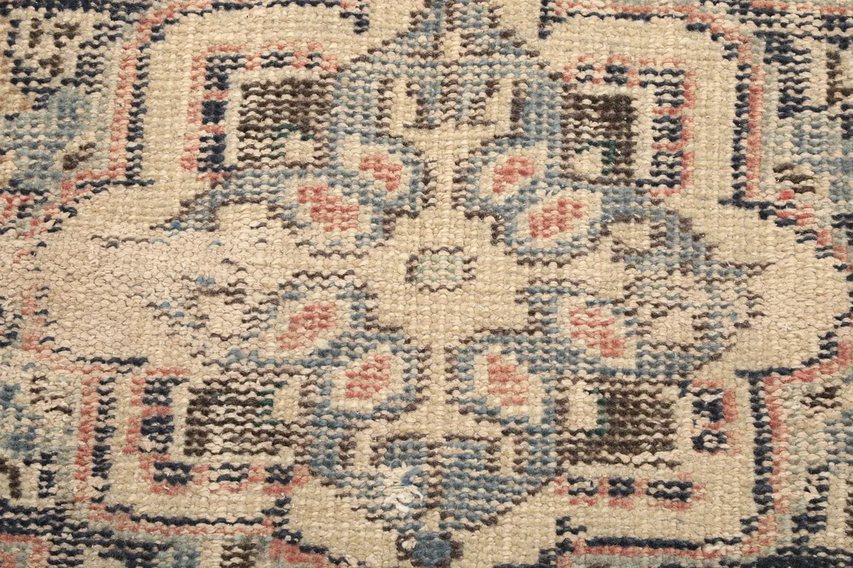 Macro detail of the hand-knotted wool pile, showing individual knots and color variations