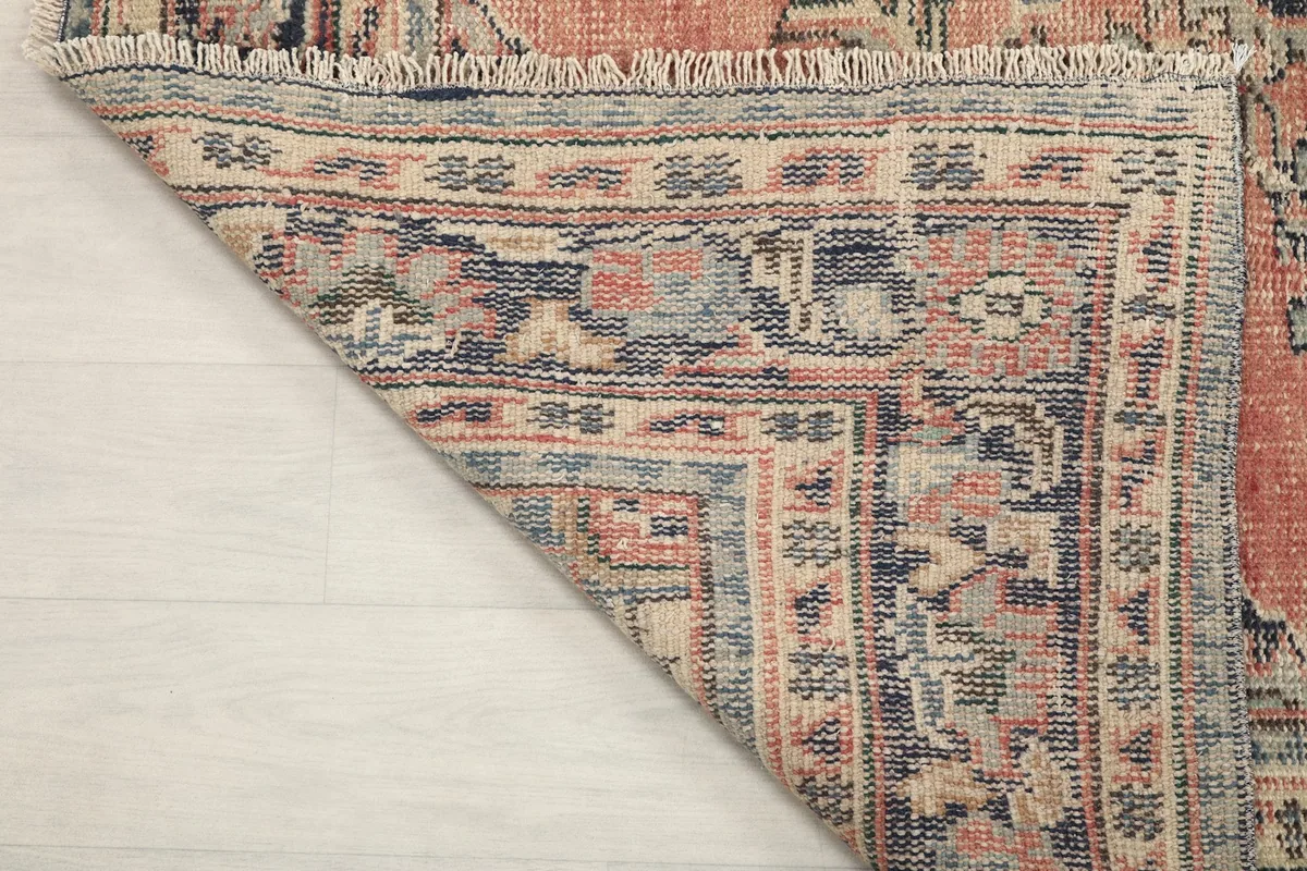 Underside view of the rug, showing the cotton foundation and tight hand-knotted wool knots
