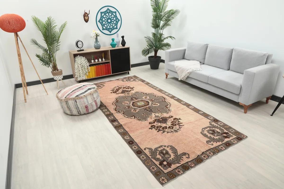 Overhead angle of the rose Anatolian rug in a living space, showing its full length and width