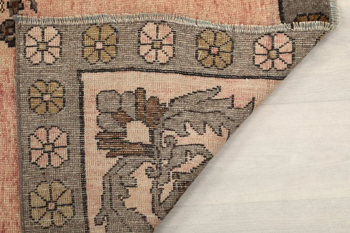 Close-up of the rug's pile and folded edge, showing the texture and construction
