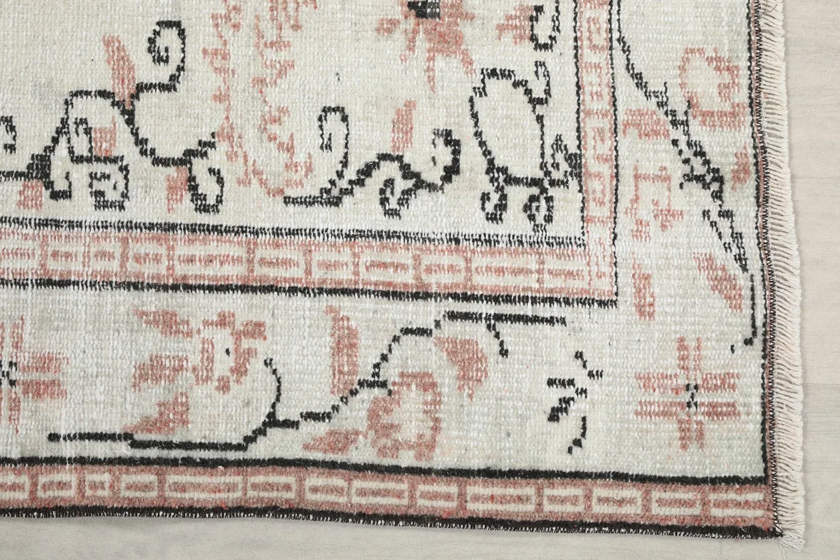 Corner detail showing the hand-knotted wool pile and border patterns.