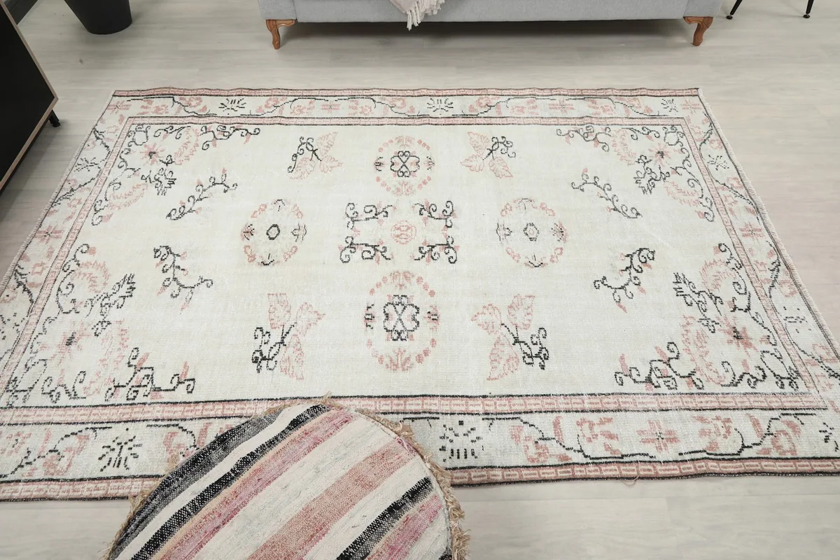Overhead shot of the vintage rug in a room, showing its full dimensions and design.