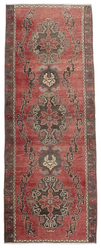 Full top view of the 3'3" x 8'11" rust geometric Anatolian runner on a white background