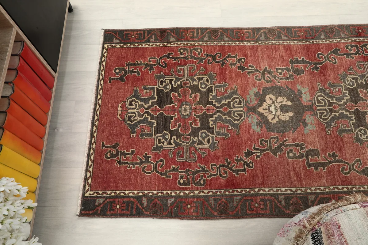 Angled view of the rust runner rug's design, highlighting its vintage texture