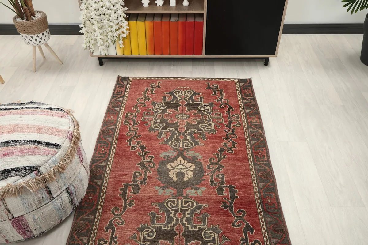 Overhead view of the rust geometric runner rug placed in a room, showing its length