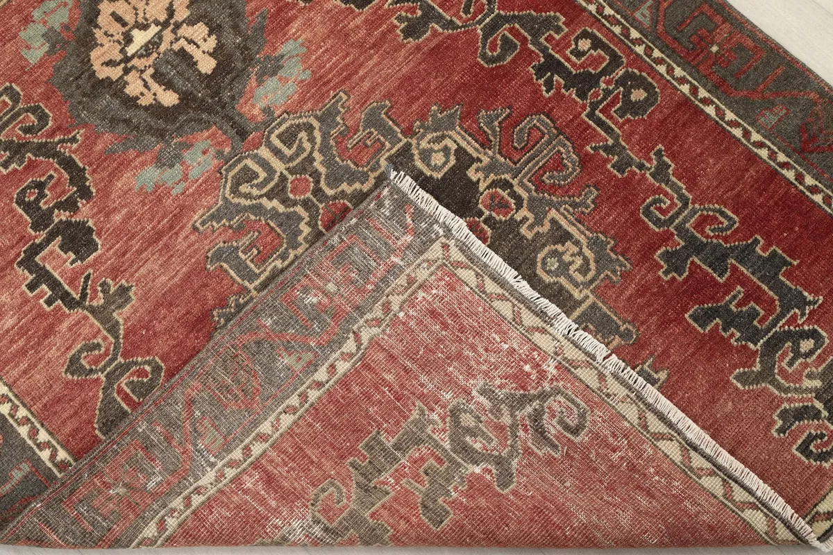 Folded corner of the rug revealing the back of the hand-knotted wool pile