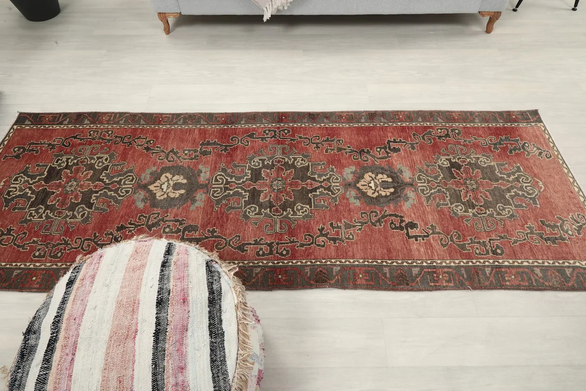 Full overhead view of the 3'3" x 8'11" rust runner rug in a room setting