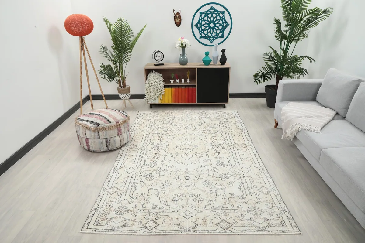 Vintage Anatolian rug in a modern living room setting with a gray sofa