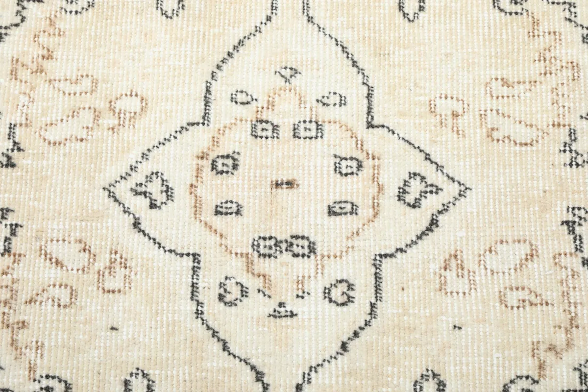 Close-up of the central medallion design with intricate gray and tan details