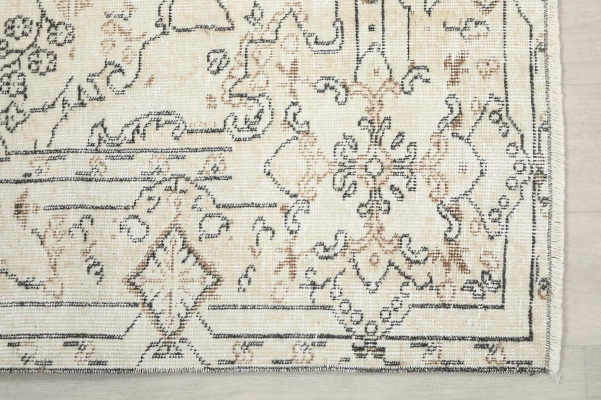 Detailed corner of the rug, highlighting the geometric border and motifs
