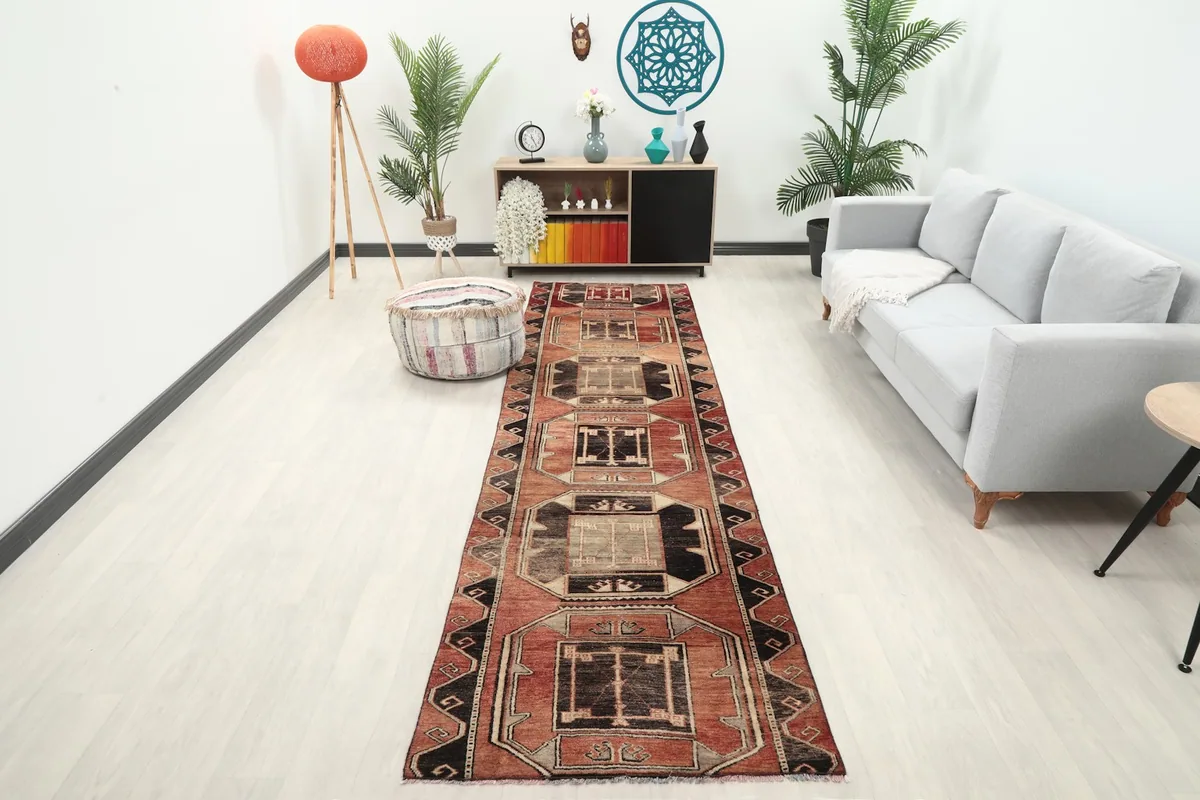 Long view of the rust geometric runner rug in a modern hallway setting