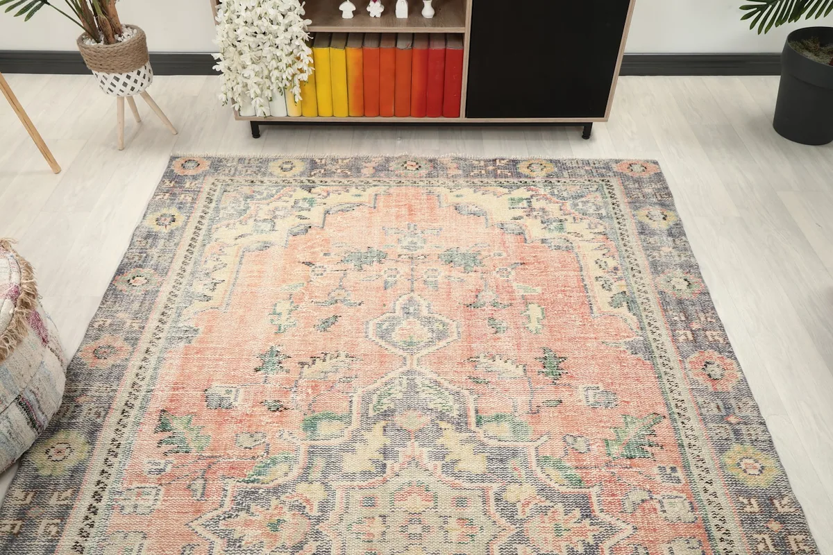 Overhead view of the vintage rug in a room, showcasing its full design and color palette.