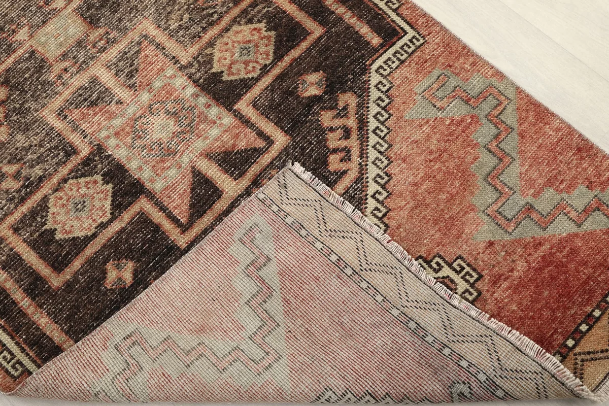 View of the back of the rug, revealing the hand-knotted cotton foundation and wool pile construction