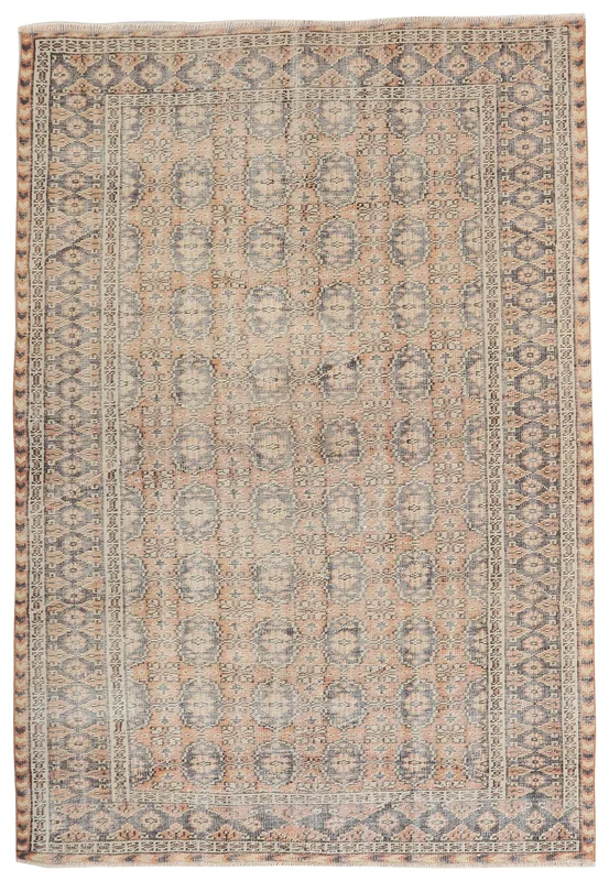 Full overhead view of the vintage Anatolian rug with tan and charcoal medallion patterns