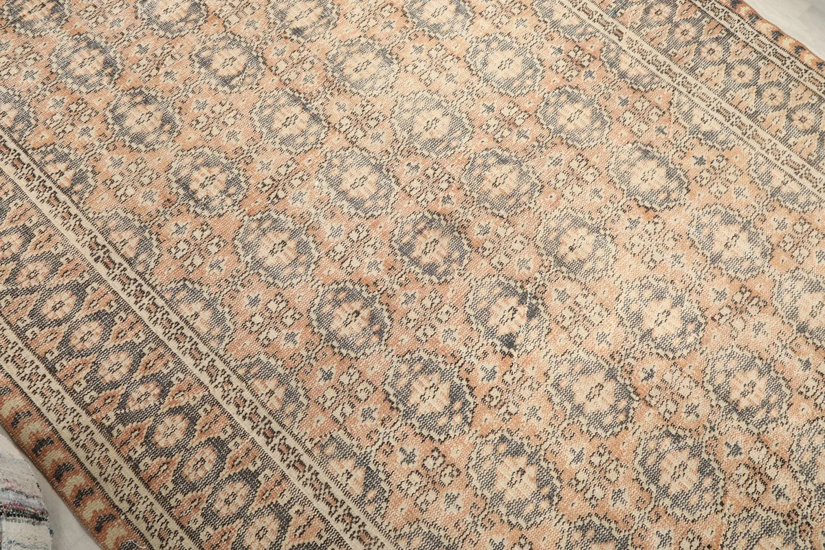 Angled view highlighting the repeating medallion patterns across the rug's surface