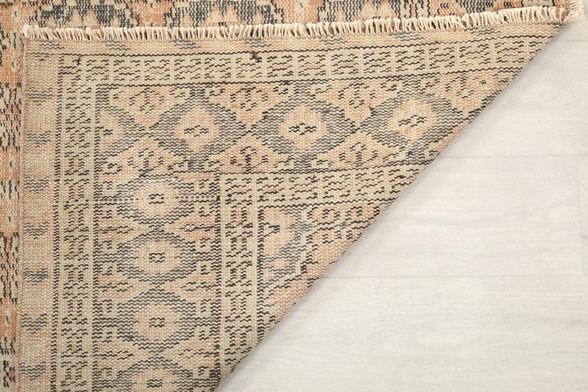 Corner of the rug's back, revealing the tight knotting and craftsmanship