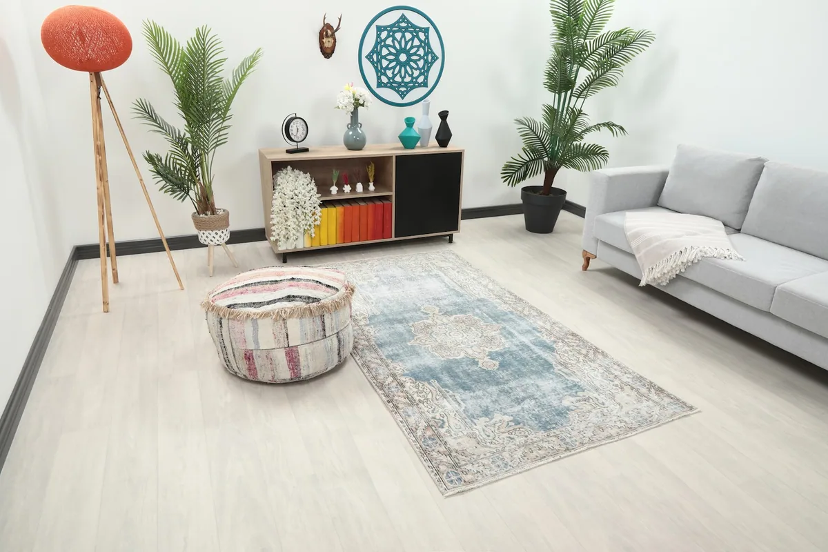 Angle view of the blue and ivory vintage rug placed in a modern living space