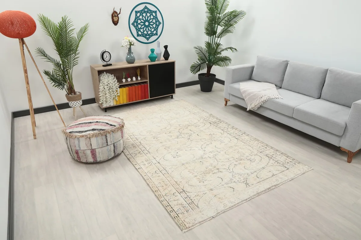 Angled view of the ivory Anatolian rug in a living room, showcasing its placement and scale.