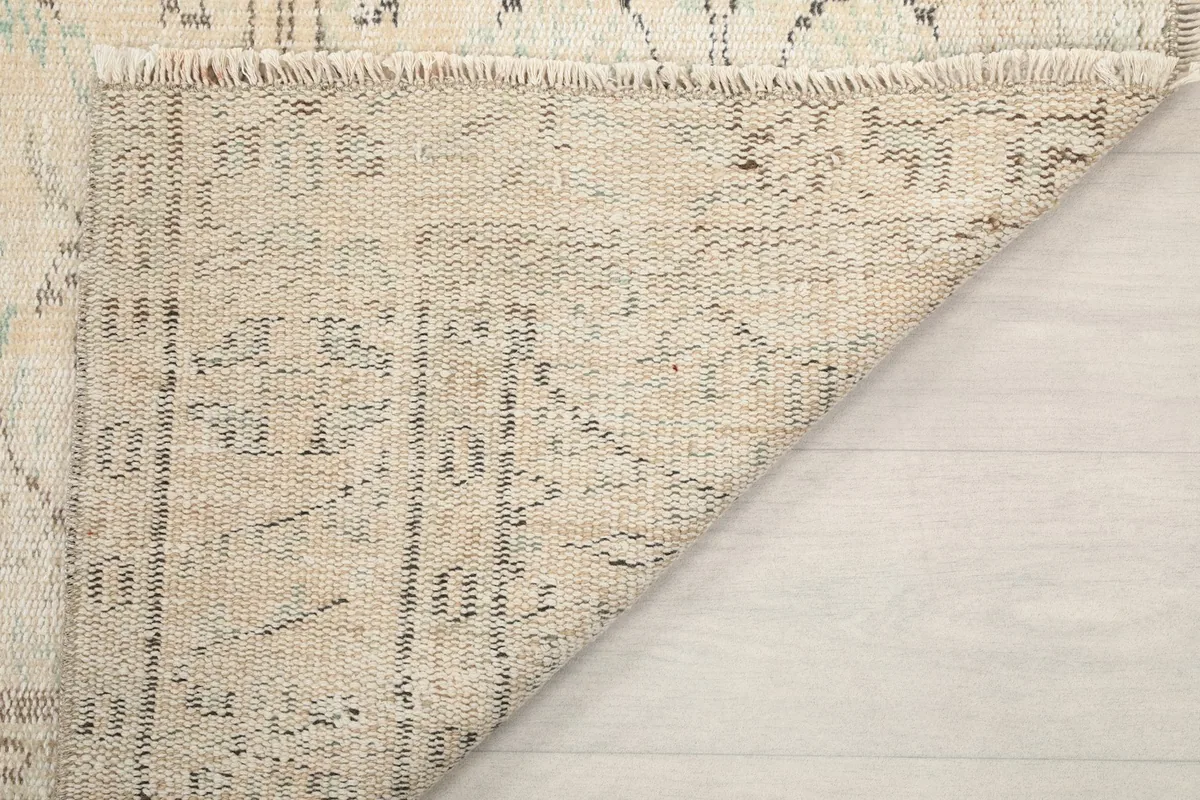Underside of the rug, showing the back of the hand-knotted construction and foundation.