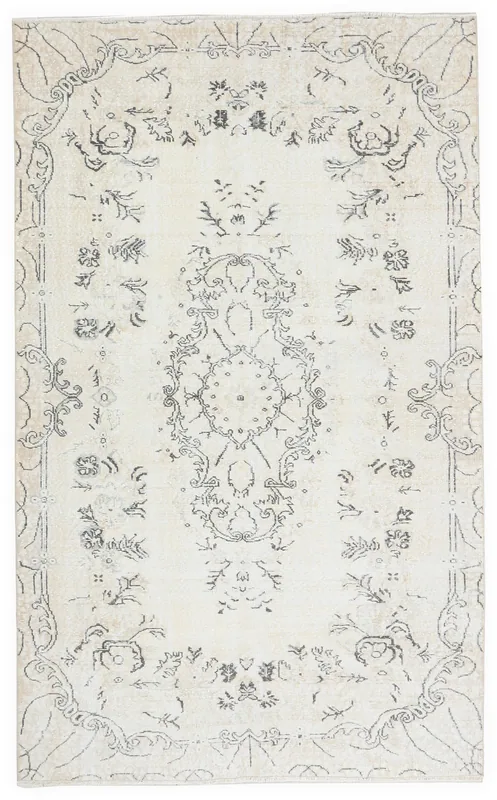 Full top view of the 5'6" x 9'3" ivory and charcoal vintage Anatolian area rug on a white background.