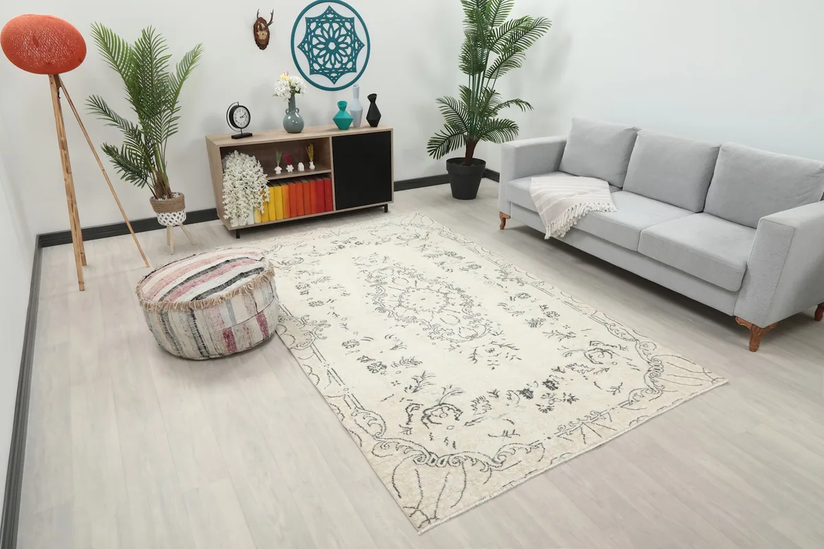 Overhead view of the ivory and charcoal rug in a living space, showing its placement relative to furniture.