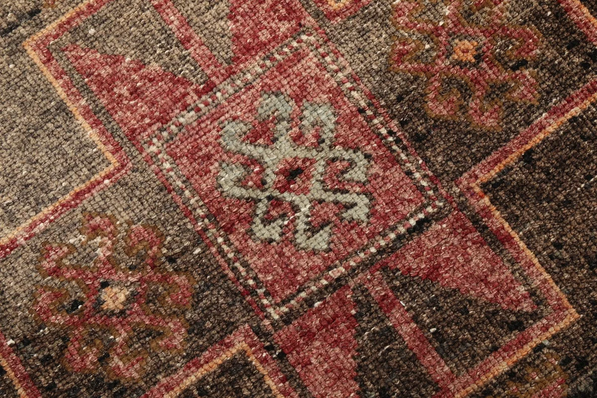 Extreme close-up of the hand-knotted wool pile, showing texture and subtle color variations