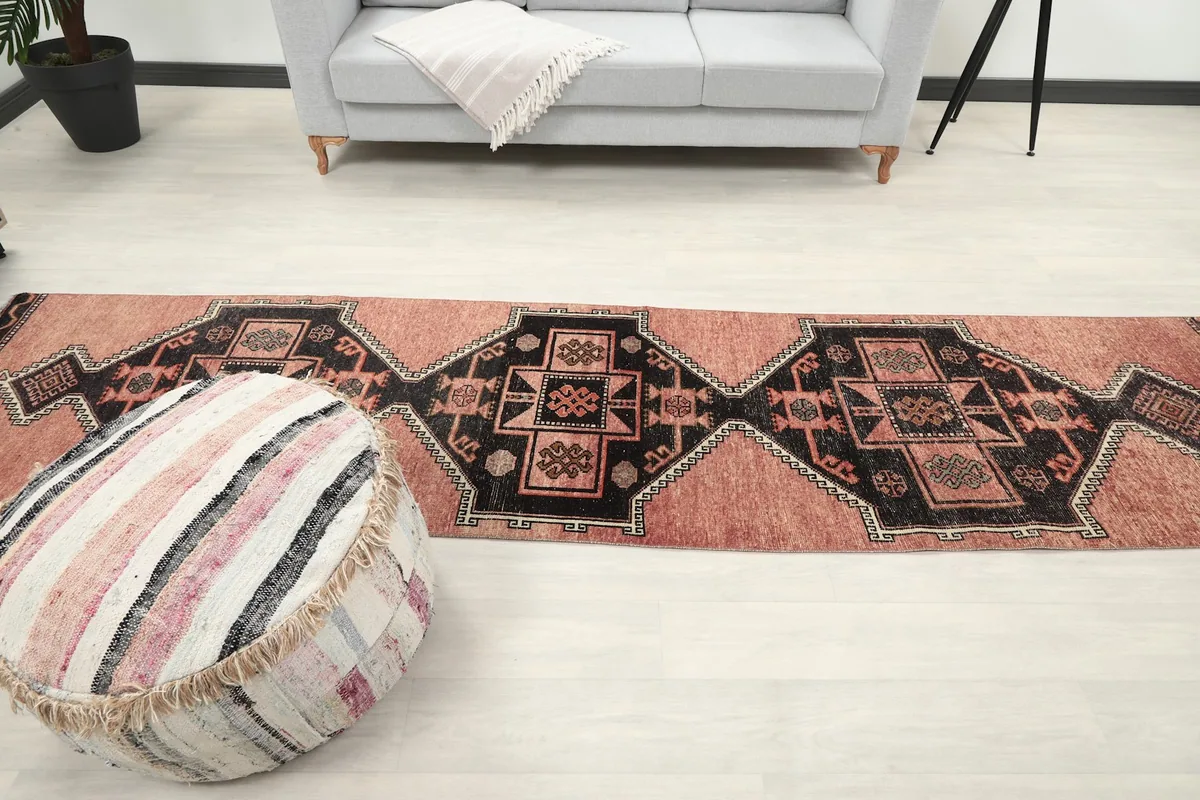 Full view of the runner rug extending through a living space with a gray couch