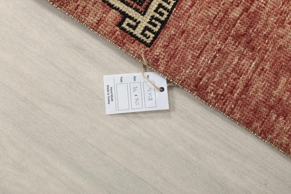 Rug corner with a product tag showing size and origin information