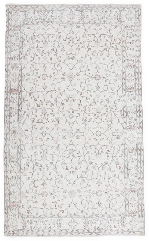 Full top view of the 5'6" x 9'2" cream and rose floral vintage Anatolian area rug on a white background.
