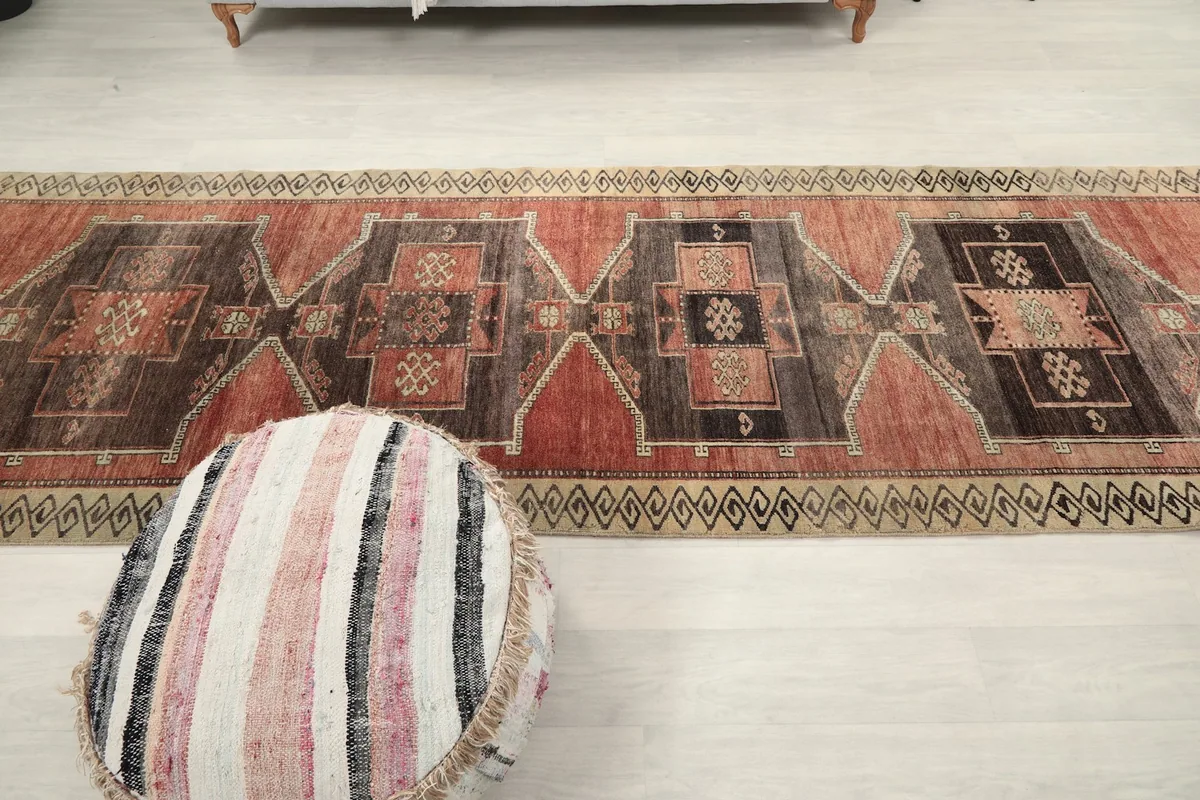 Long view of the vintage runner rug in a room, showing how it defines the space
