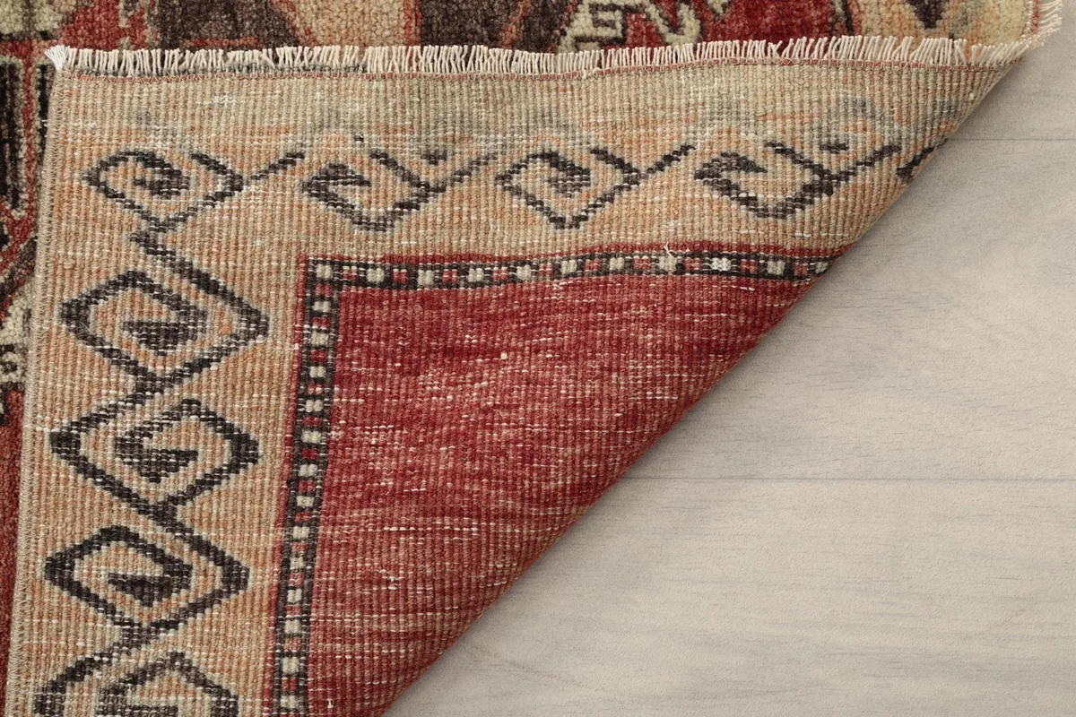 Underside view of the rug revealing the cotton foundation and fine hand-knotting