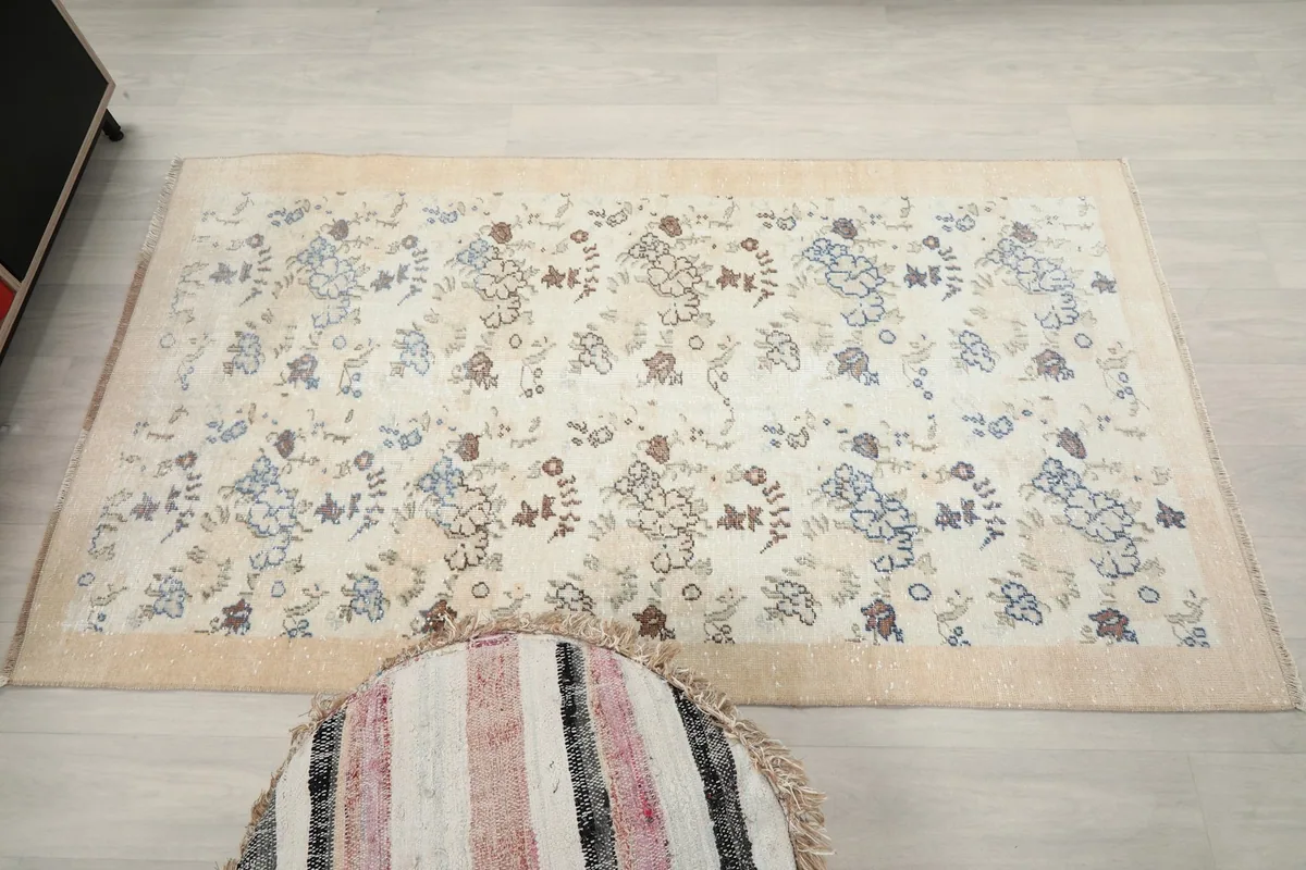 Flat overhead shot of the cream rug, showing its rectangular shape and pattern distribution