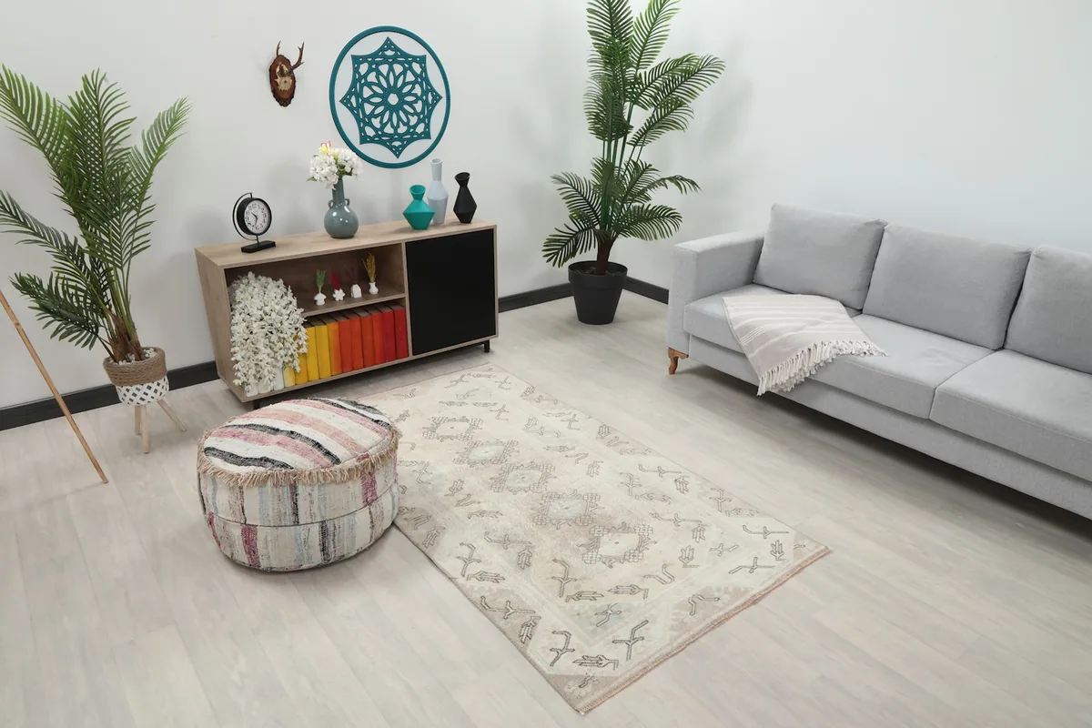 Overhead view of the beige tribal rug in a living space, showcasing its size relative to furniture.