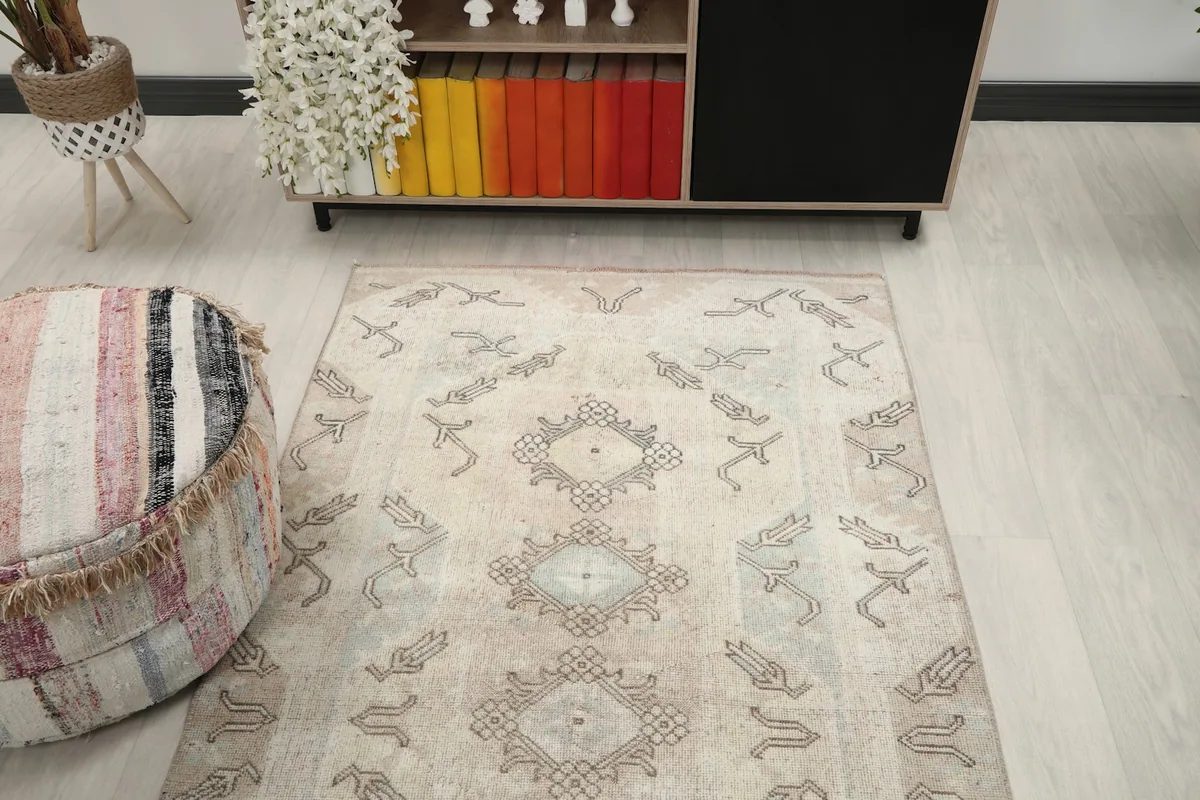 Overhead view of the rug's central design and surrounding tribal elements in a room setting.