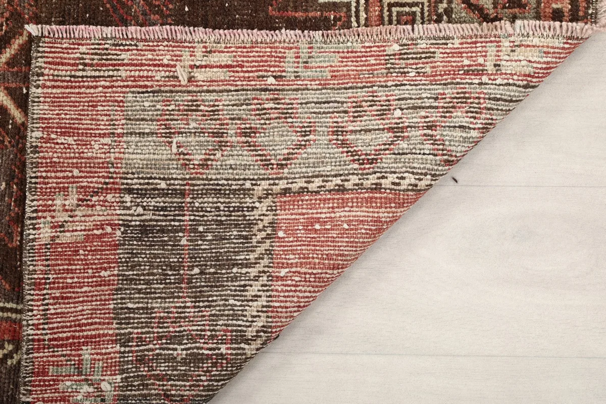 Underside of the rug, revealing the woven cotton foundation and knotting structure