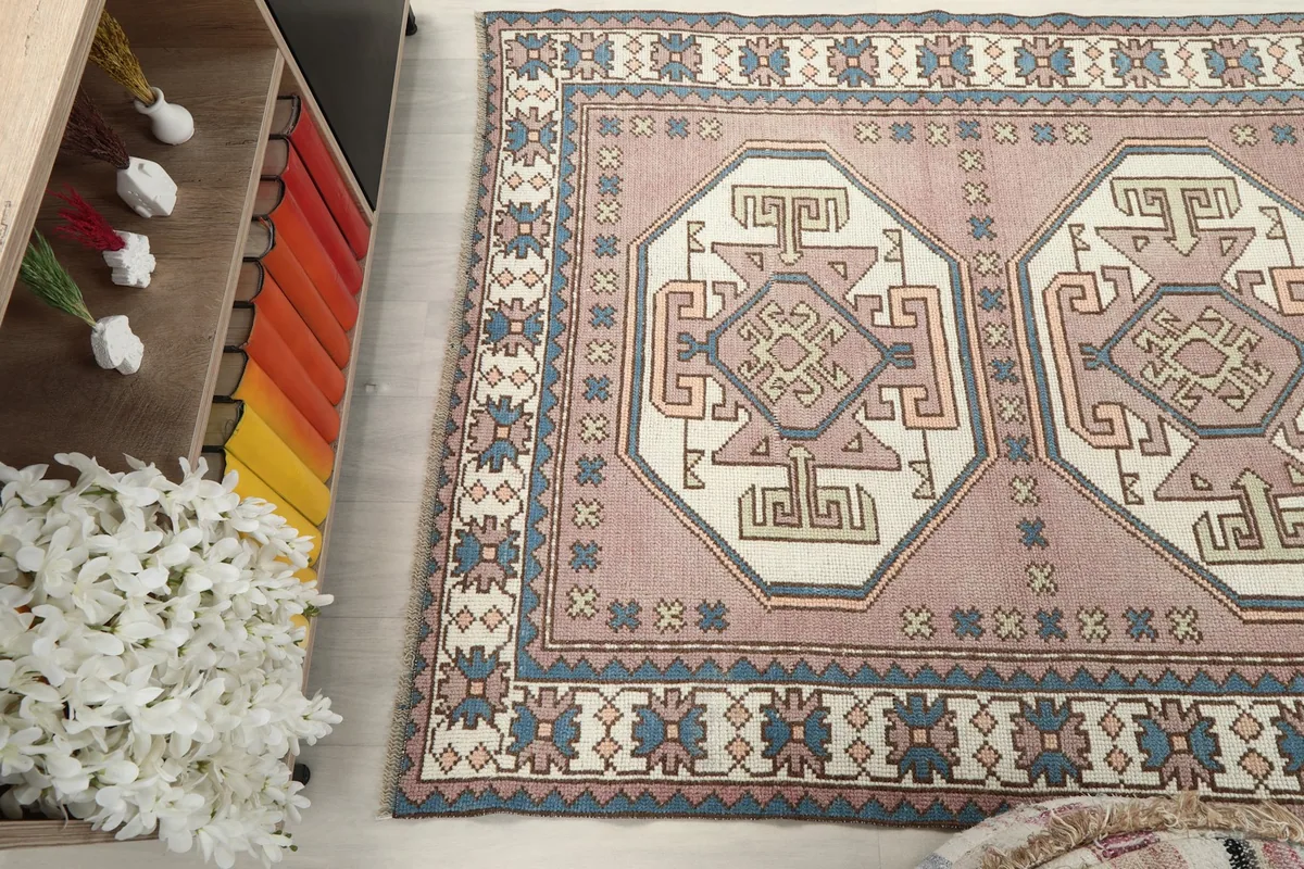 Side view of the rug in a room, emphasizing its length and border design