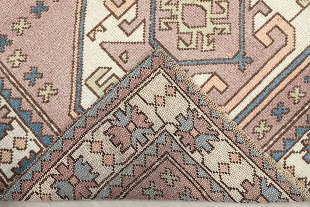 Folded corner of the rug, revealing the back of the hand-knotted cotton foundation