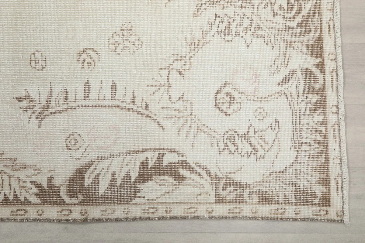 Detail of the brown and beige border design on the vintage Anatolian rug