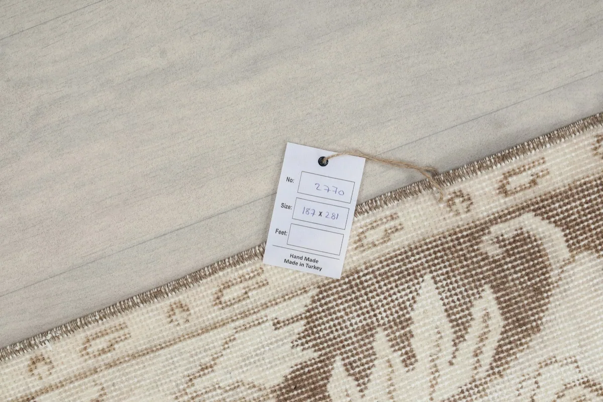 Tag on the back of the rug confirming its hand-knotted origin in Turkey