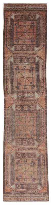 Full overhead view of the rust and brown geometric Anatolian runner rug on a white background