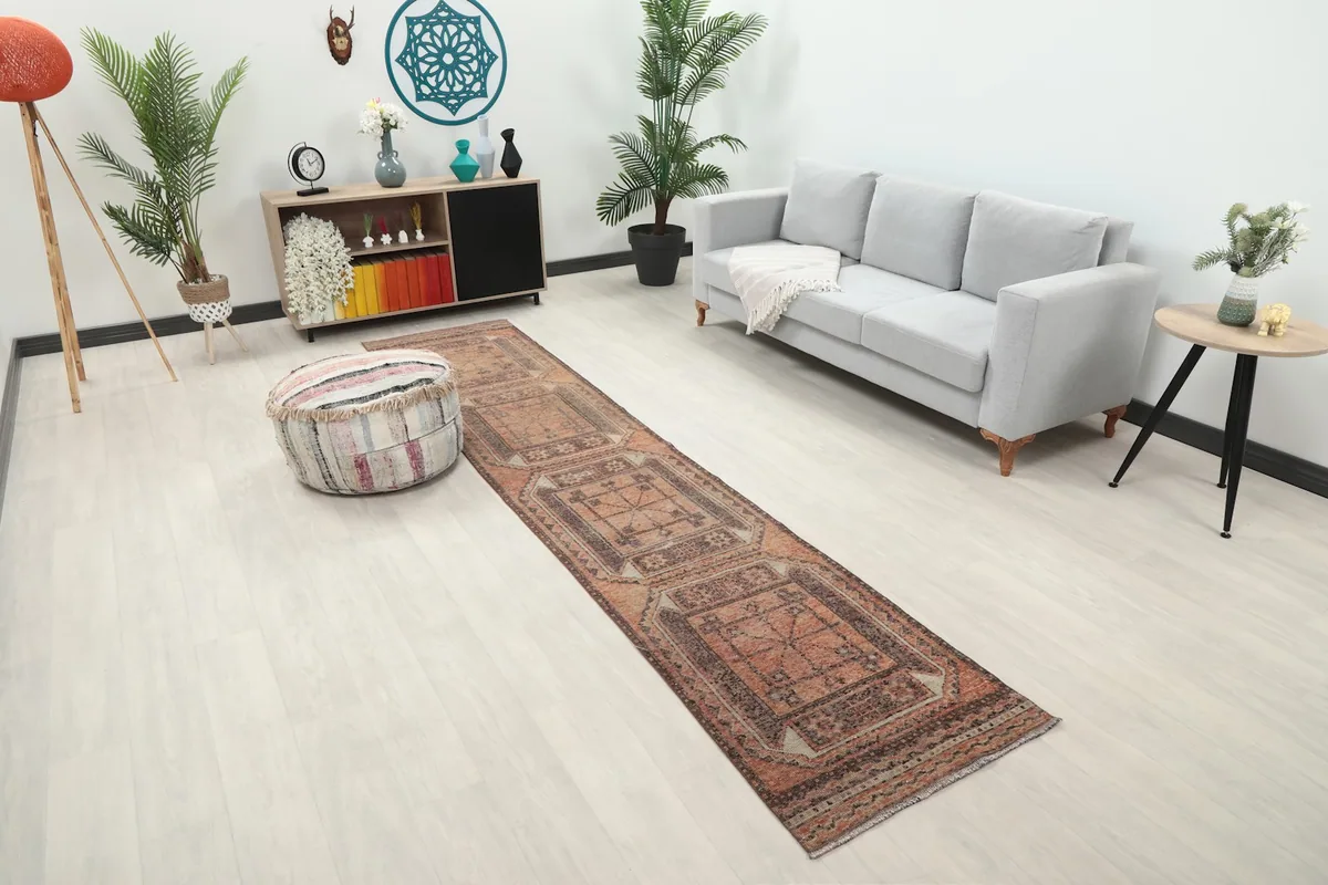 Diagonal view of the rust and brown vintage runner rug extending through a living space
