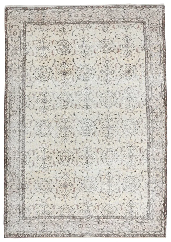 Full overhead view of the 6'11" x 10'1" ivory and brown floral vintage Anatolian area rug