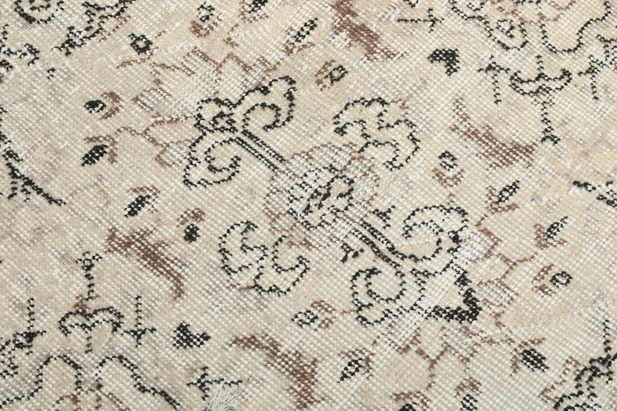 Texture and low pile detail showing the individual knots and color variations of the rug