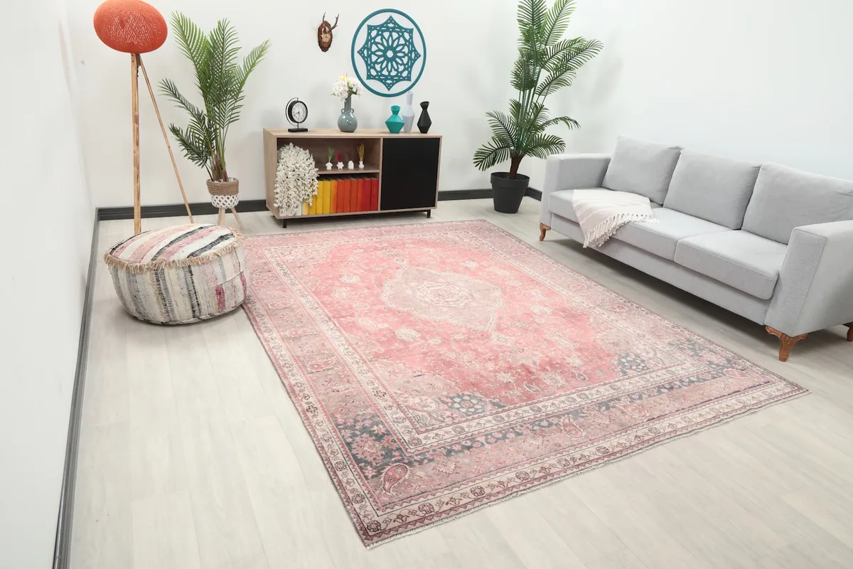 Angled view of the rose Anatolian rug in a modern living space with plants and decor