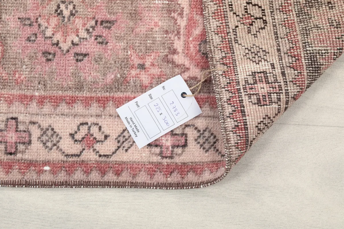 Corner of the rug with a product tag showing size and material information