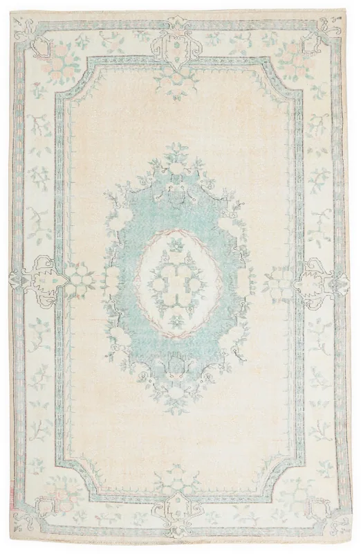 Full overhead view of the cream and green floral medallion vintage Anatolian rug