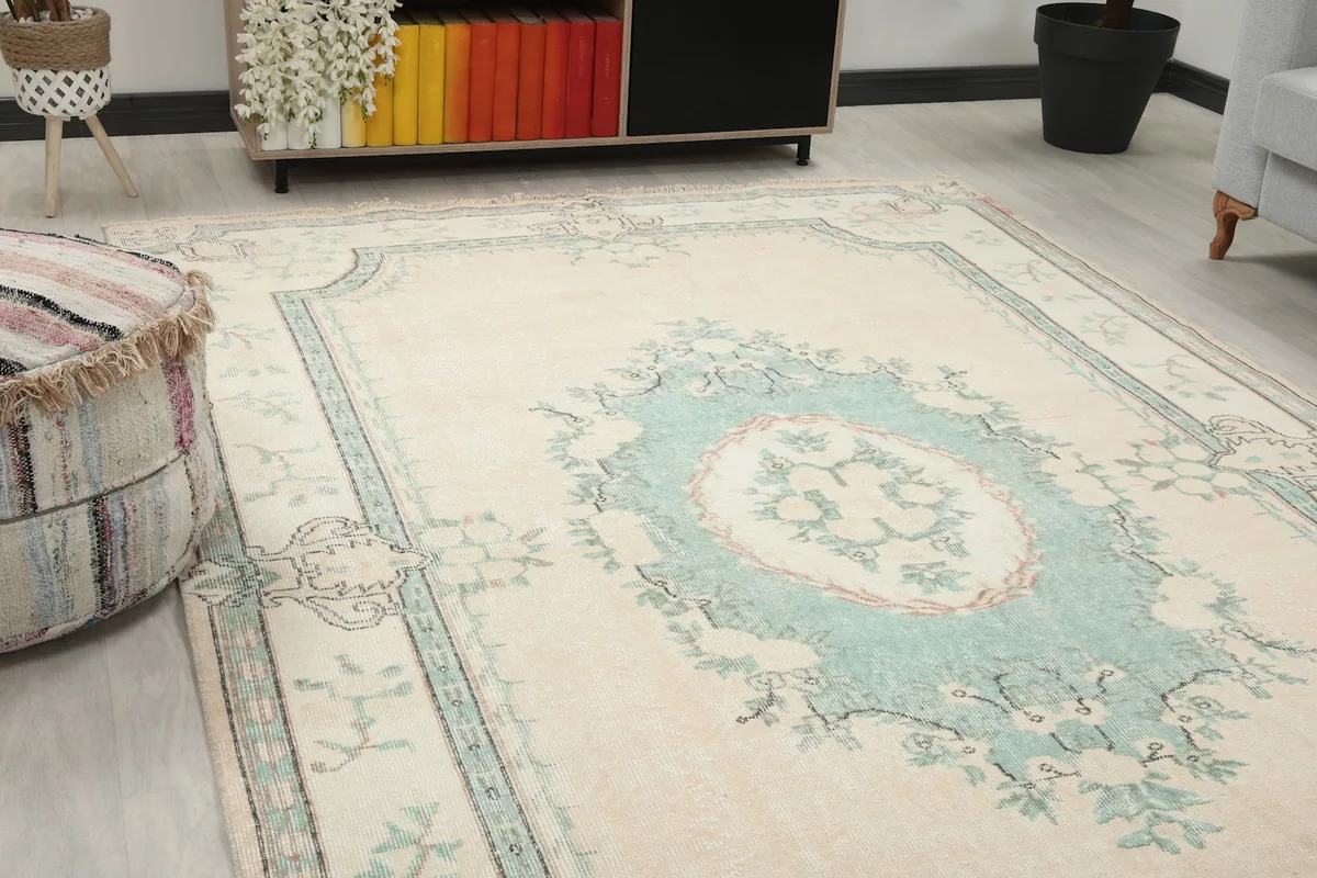 Close-up angled view of the cream field and green floral medallion design