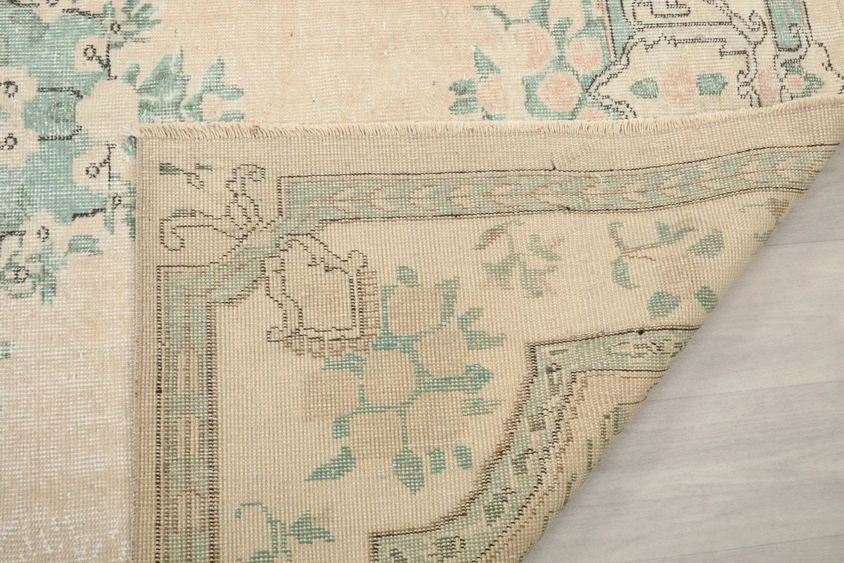 Another folded corner, revealing the reverse side and weave of the vintage rug
